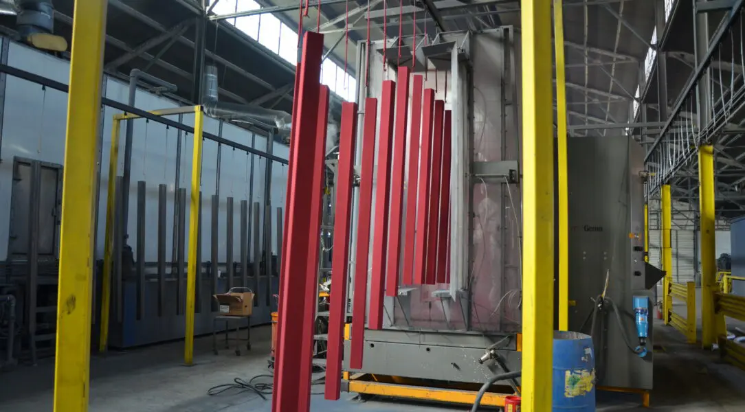 A large red pipe hanging in an industrial setting.