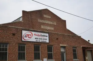 A brick building with a sign on the side of it.